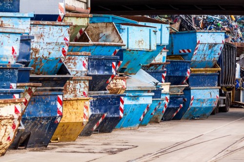 Workers wearing PPE loading a refuse vehicle with separated commercial waste