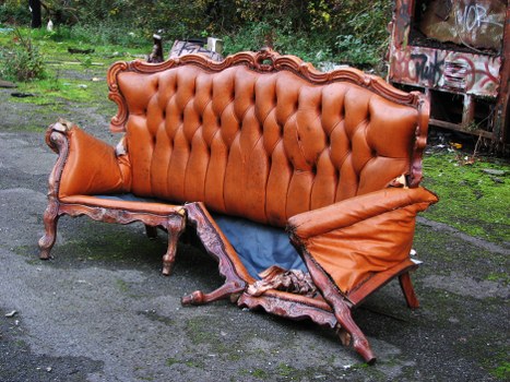 Operative handling commercial waste bin at a collection point